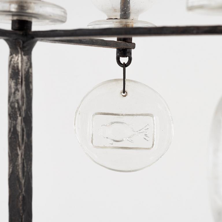 Erik Höglund, a iron and glass candelabra.