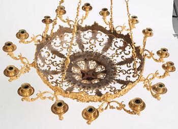 A rococo-revival gilt-brass sixteen-light chandelier, mid 19th century.
