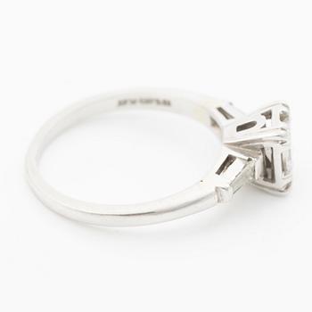 Platinum ring with an emerald-cut diamond and modified baguette-cut diamonds.
