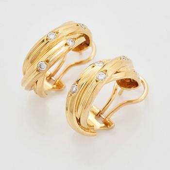 A pair of Cartier "Trinity" earrings in 18K gold set with round brilliant-cut diamonds.