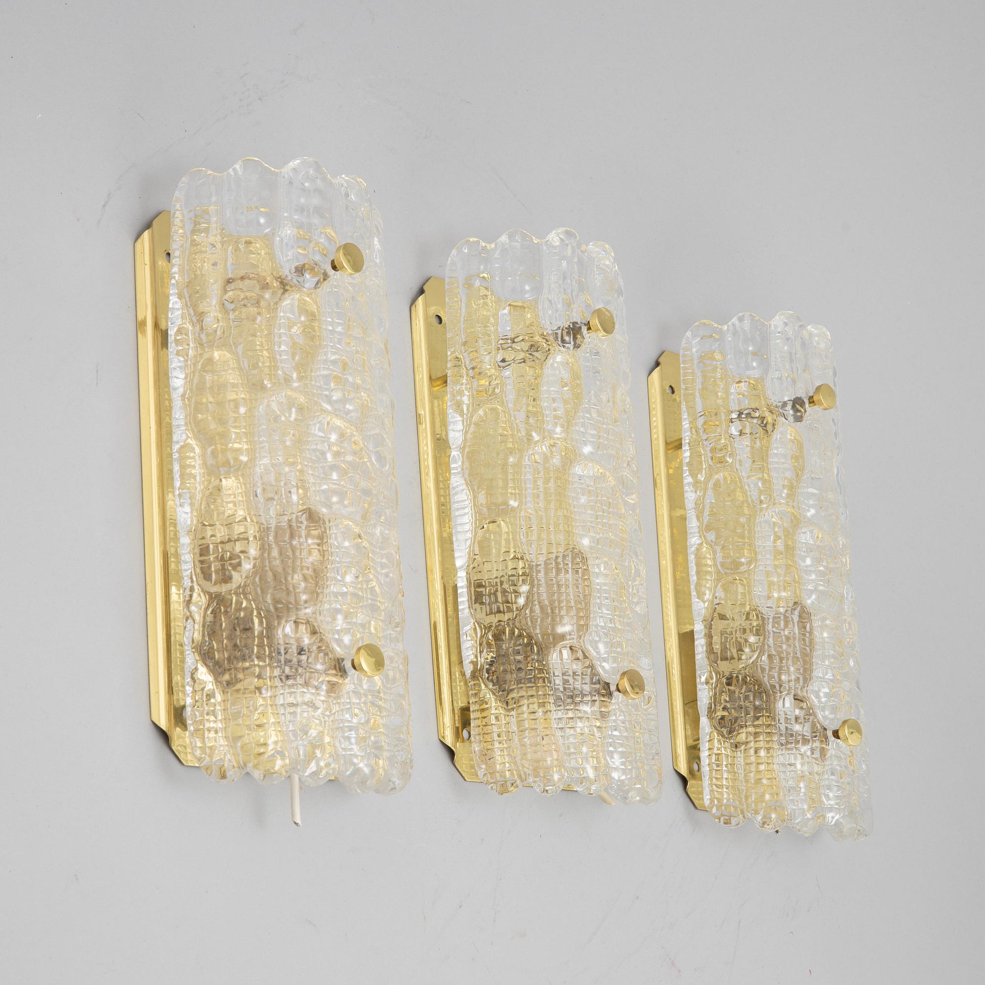 Carl Fagerlund, a set of three glass and brass wall lights, Orrefors/Nya ÖIA, second half of the 20th Century.