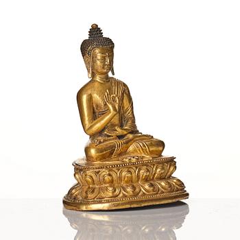 A gilt bronze figure of buddha, Tibet, presumably 18/19th Century.