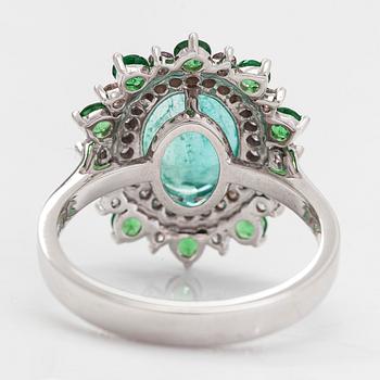 A 14K white gold ring with an emerald 2.40 ct, tsavorites 0.75 ct and diamonds ca 0.42 ct. With IGI certificate.