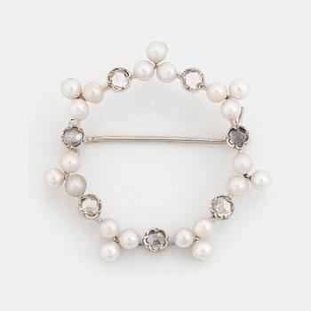 An 18K white gold WA Bolin brooch set with pearls and rose-cut diamonds.