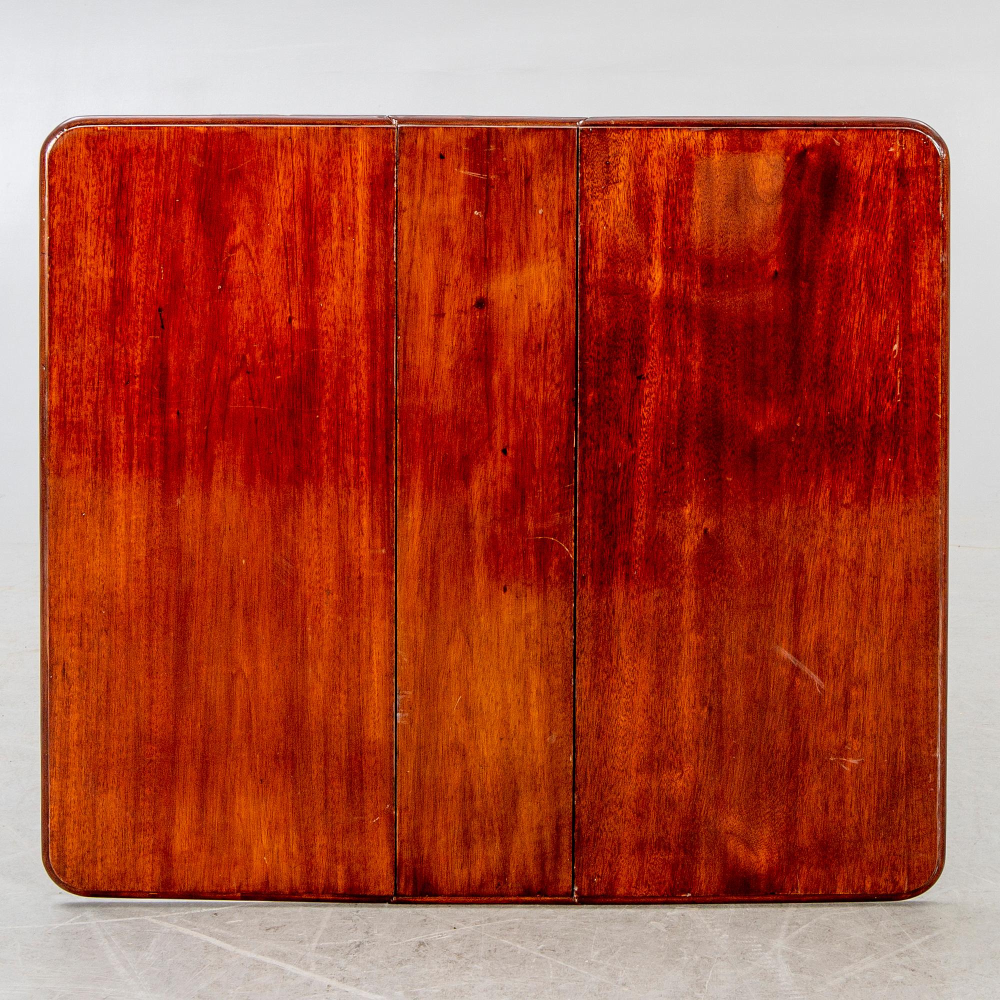 A 20th century English mahogany folding table.