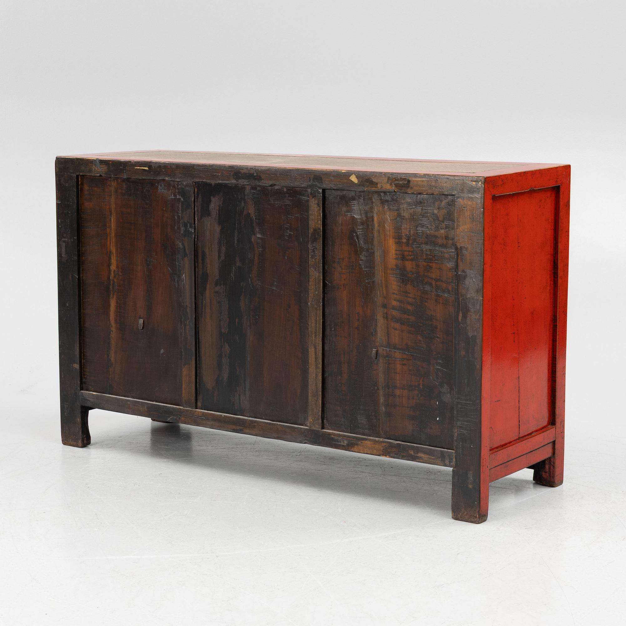 A Chinese red lacquered cabinet, 20th century.