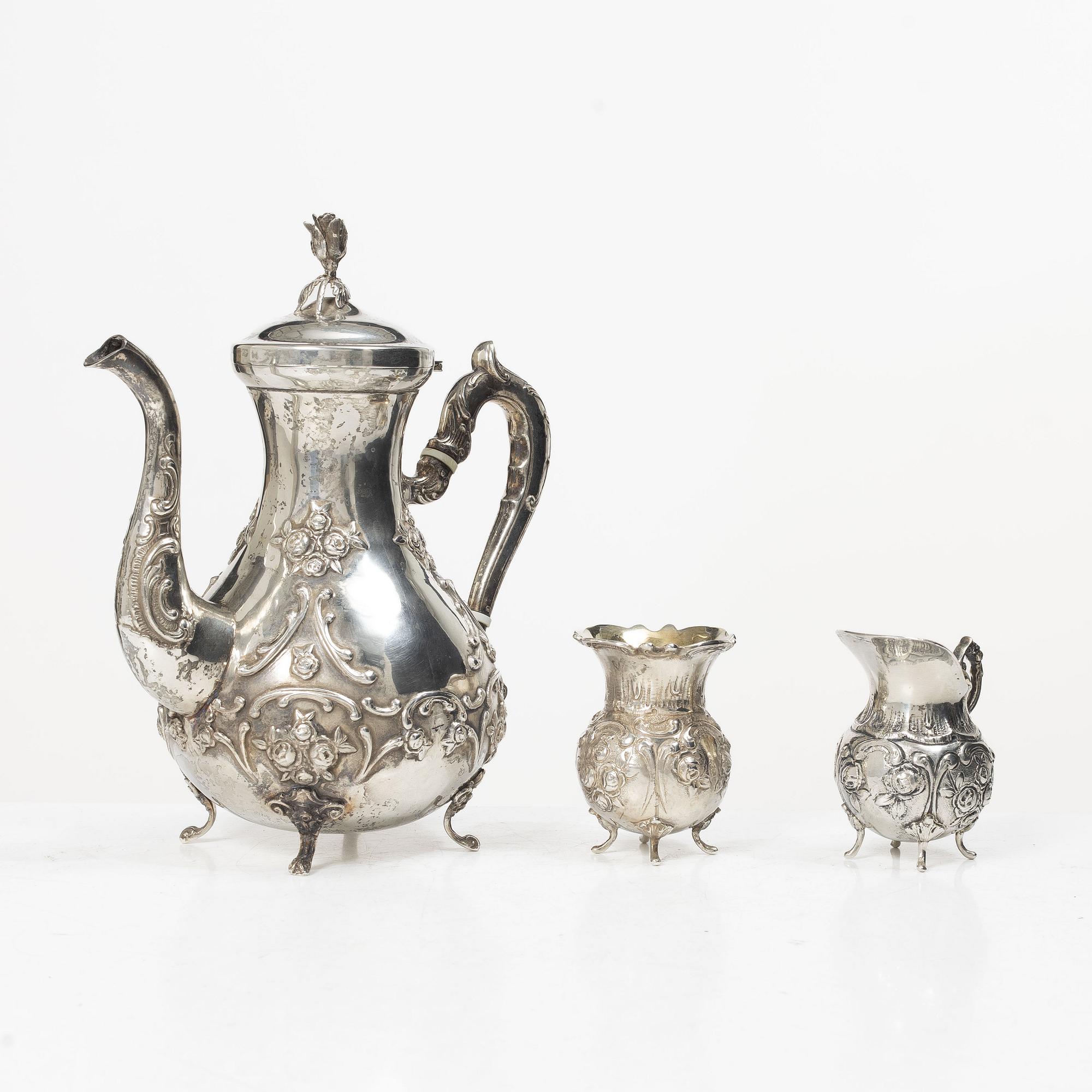 A silver Rococo style coffee pot, creamer and sugar bowl, Swedish import mark of Gewe Silvervarufabriken Ab, Malmö, 1977.
