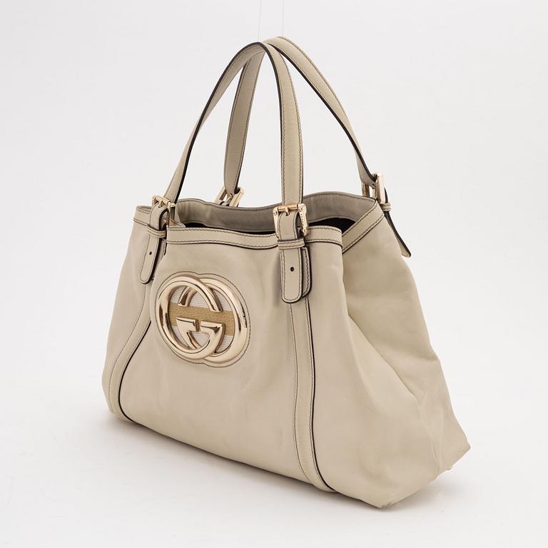 Gucci, a cream leather handbag.