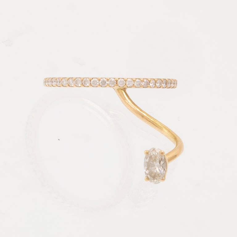 An 18K gold ring set with an oval cut and round brilliant cut diamonds by LWL Jewelry.
