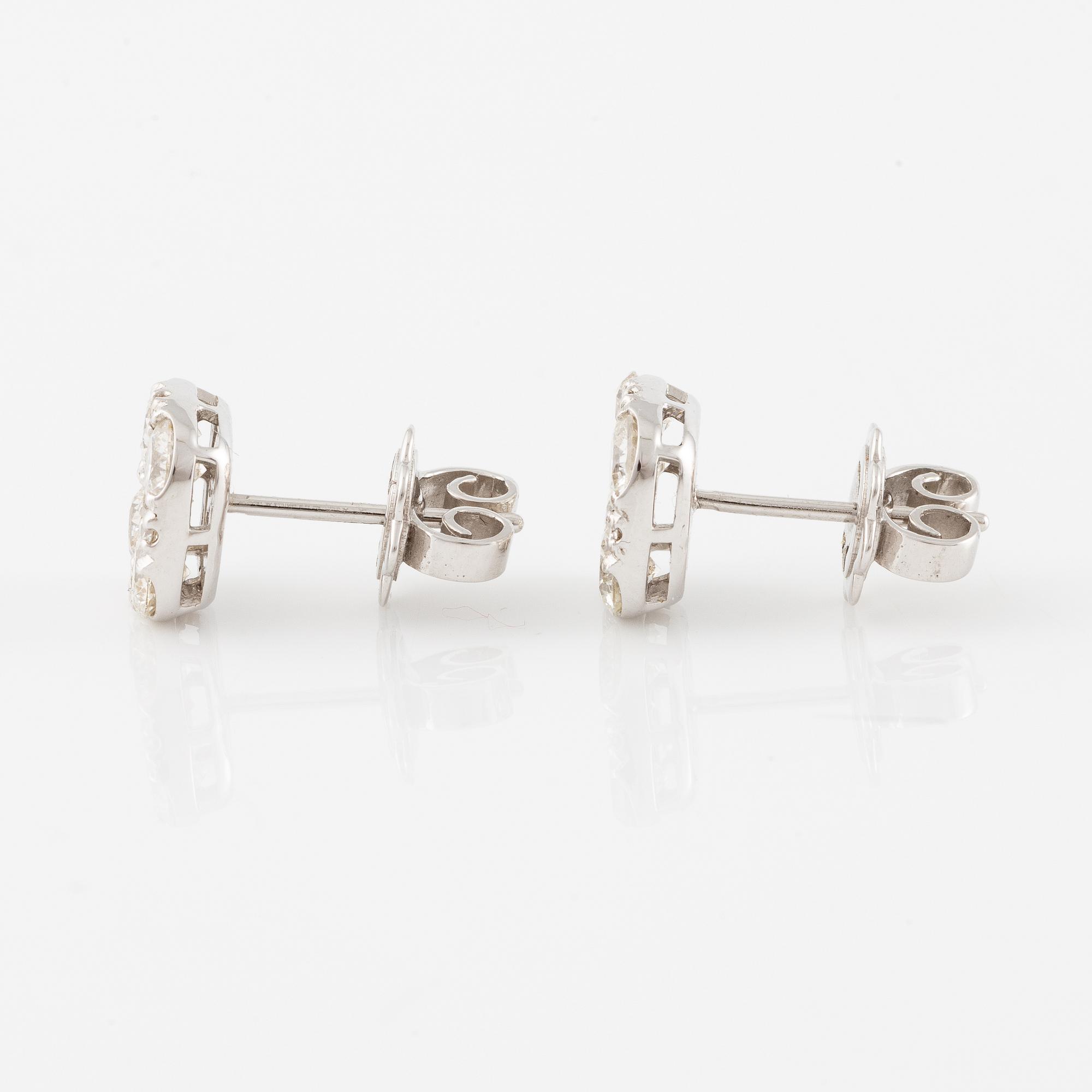 A pair of earrings in 18K white gold set with round brilliant-cut diamonds.