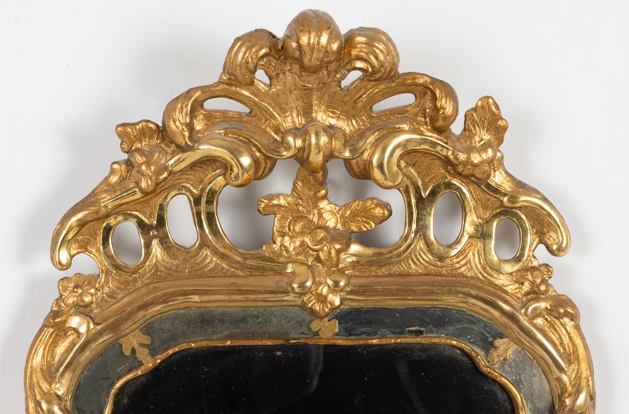A Swedish giltwood rococo mirror, Stockholm, ltaer part 18th century.
