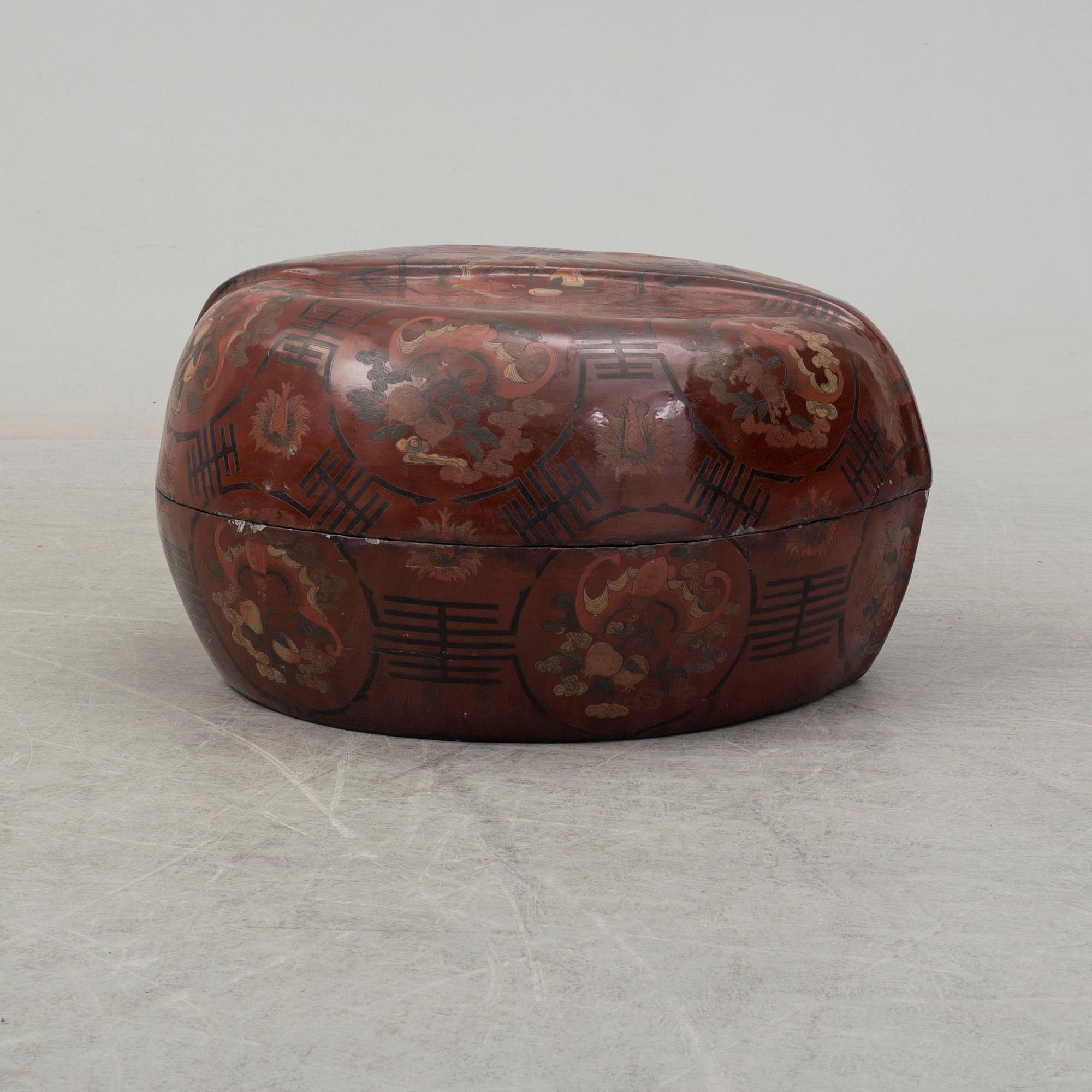 A massive Japanese wooden and lacquered box with cover, in the shape of a peach, early 20th century.