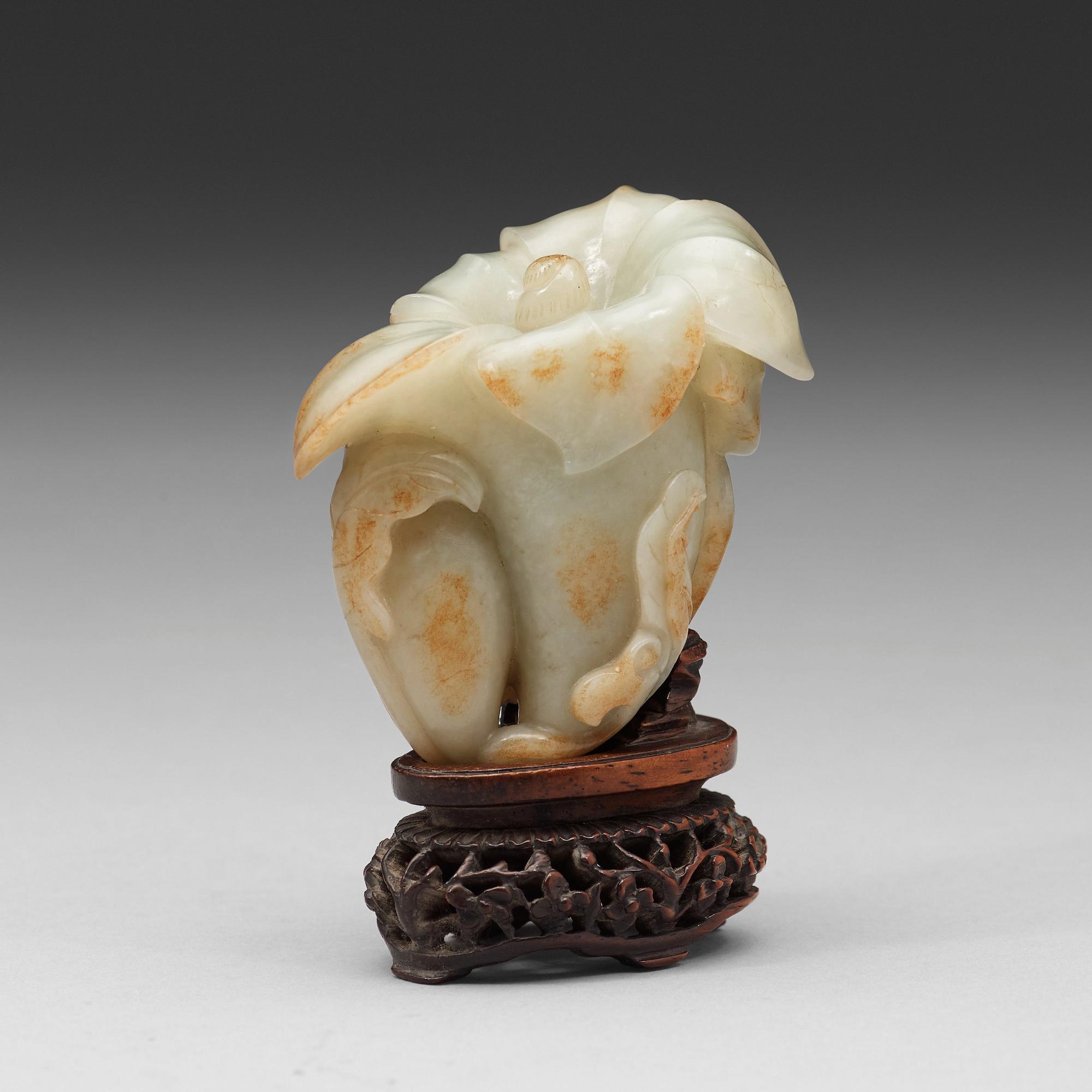 A celadon nephrite floral group, Qing dynasty (1644-1944).