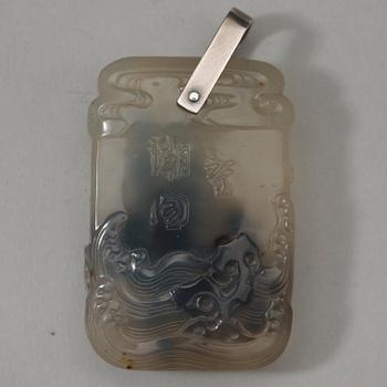 A carved dendric quarts pendant with figures on a terrace, and characters on the reverse, Qing dynasty, 19th Century.