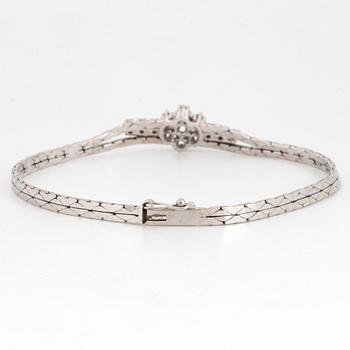 An 18K white gold bracelet set with round brilliant-cut diamonds.