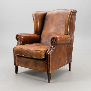 A Chesterfield style armchair from the latter part of the 20th century.