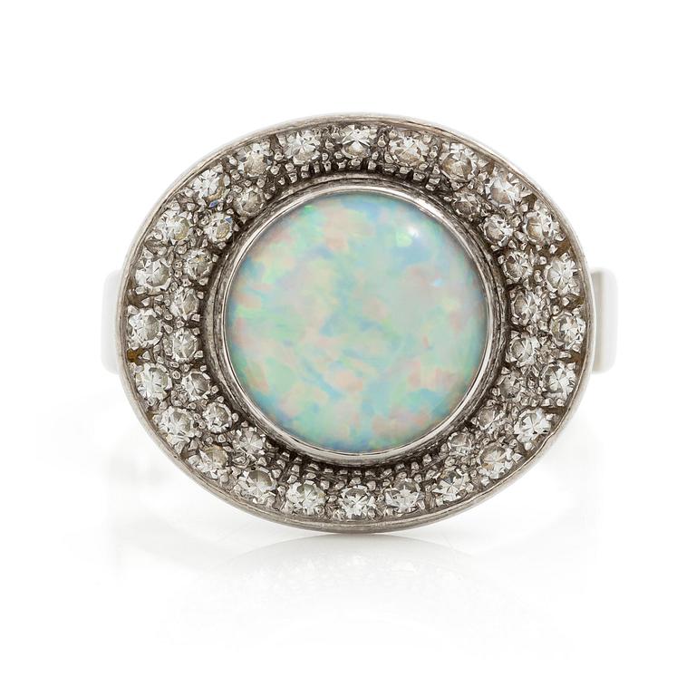 A ring 18K white gold set with an opal and eight-cut diamonds. CF Carlman, Stockholm 1973.