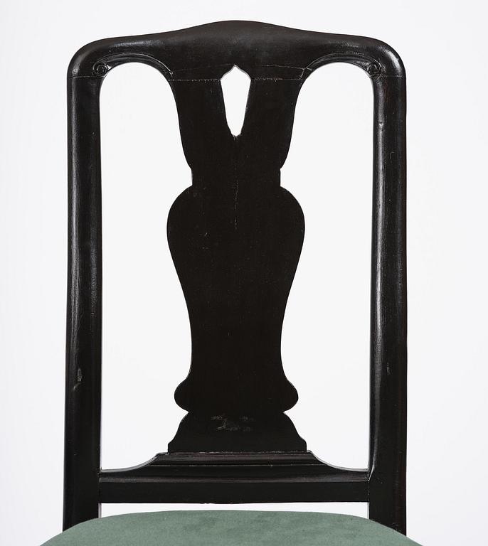 A set of eight black Swedish rococo chairs.