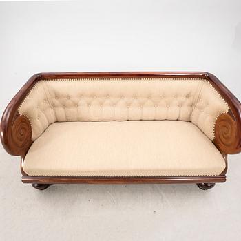 An early 1900s Art deco walnut sofa.