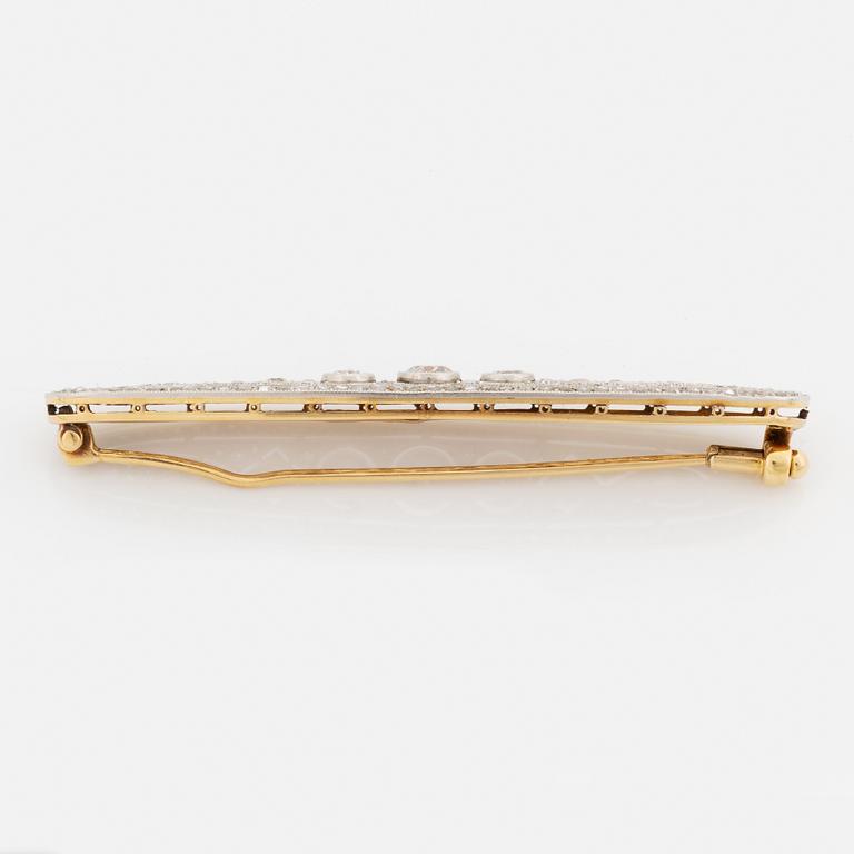 A platinum and 18K gold brooch set with old- and rose-cut diamonds.