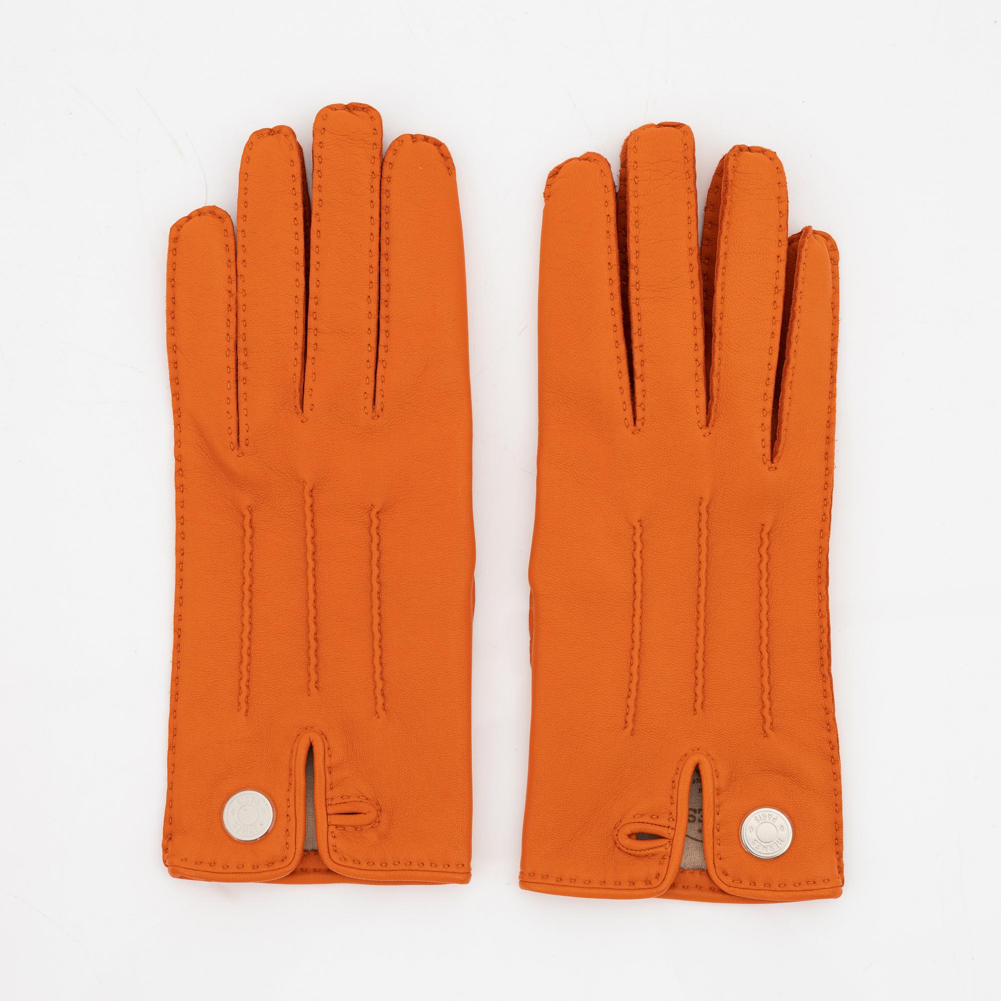 Hermès, a pair of orange kidskin and lambskin gloves, french size 7 1/2.