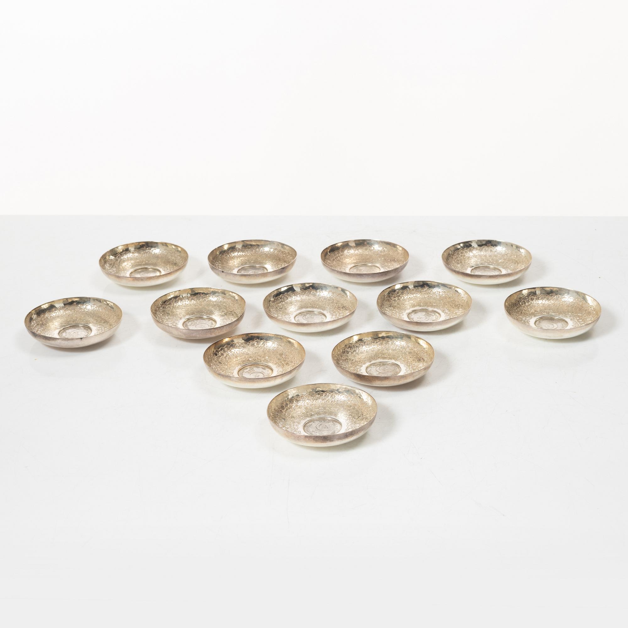12 silver ashtrays with inlaid coins, silver, Pakistan, mid 20th century.