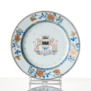 A Chinese Export armorial dish and seven plates, Qing dynasty, 18th Century.