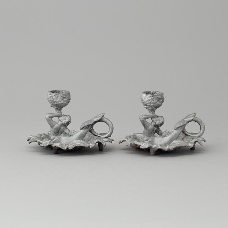 A pair of cast iron candlesticks, marked Verlag bei, A. Meves, Berlin, late 20th century.