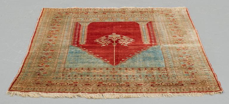 A RUG, an antique silk Tabriz, ca 165 x 122,5 cm.