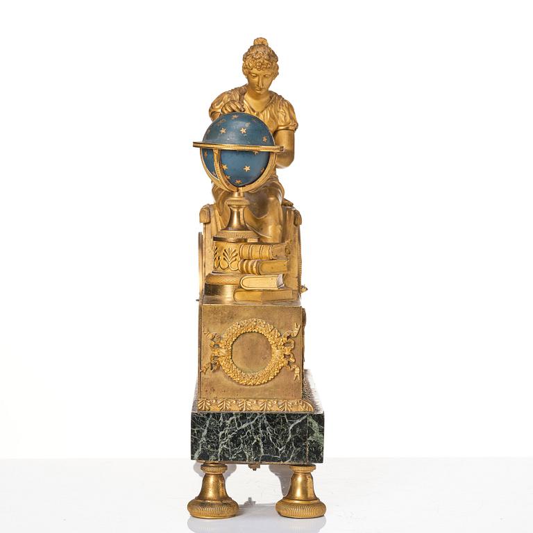 A patinated, ormolu, and marble French Empire figural mantel clock, early 19th century.