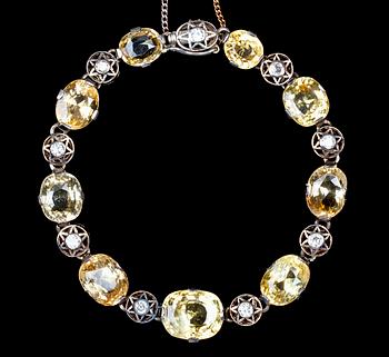 1034. A yellow sapphire and diamond bracelet, c. 1900.