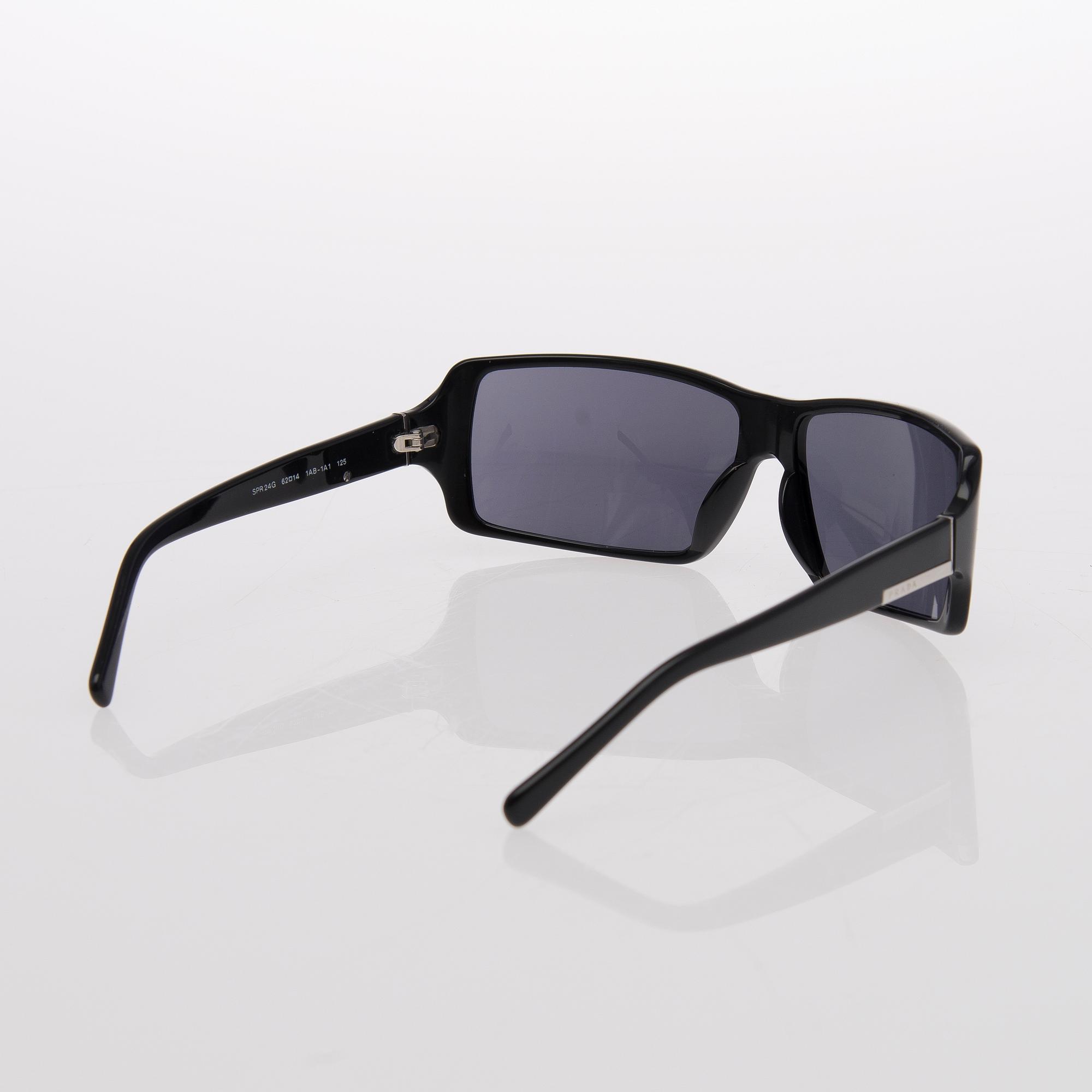 Two Pairs of Sunglasses, Prada and Chanel.
