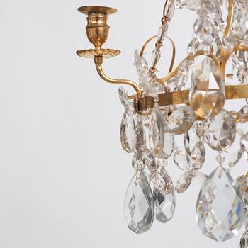 A Gustavian gilt-brass and cut-glass four-branch chandelier by O. Westerberg (master in Stockholm 1769-1881), dated 1795.