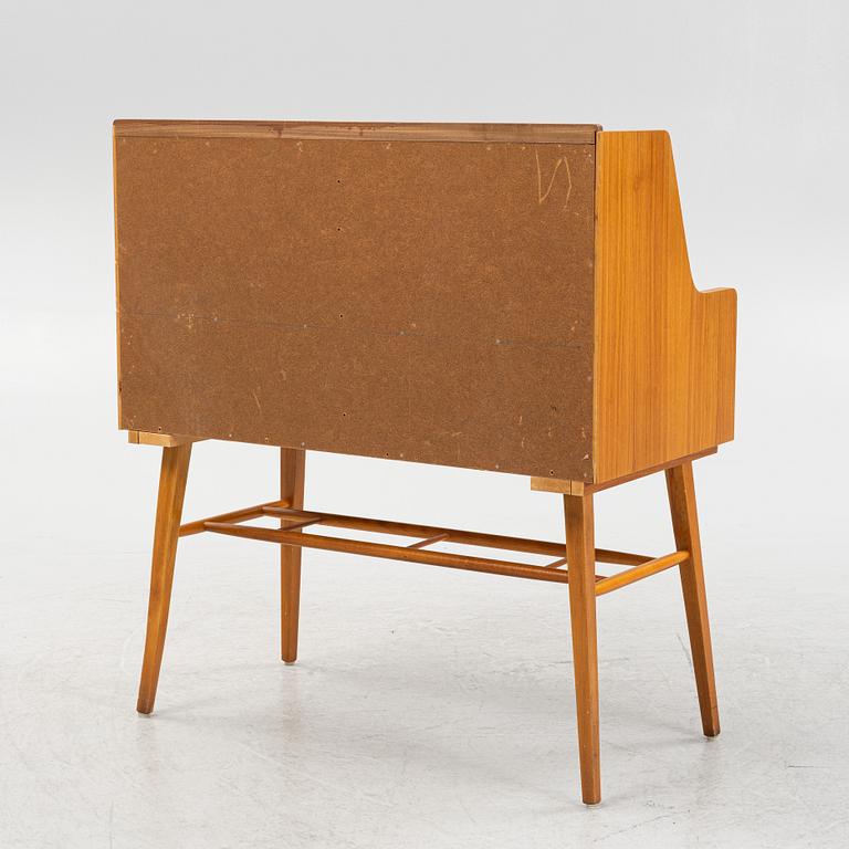 A teak-veneered desk, mid 20th century.