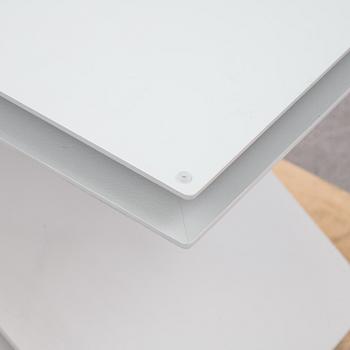 A grey lacquered metal and glass sofa table.