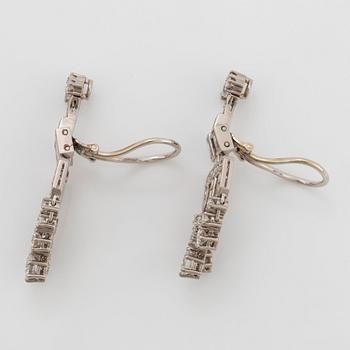 Ett par örhängen med runda briljant- och baguetteslipade diamanter.