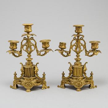 A table CLOCK and a pair of candelabra, second part of 19th century.