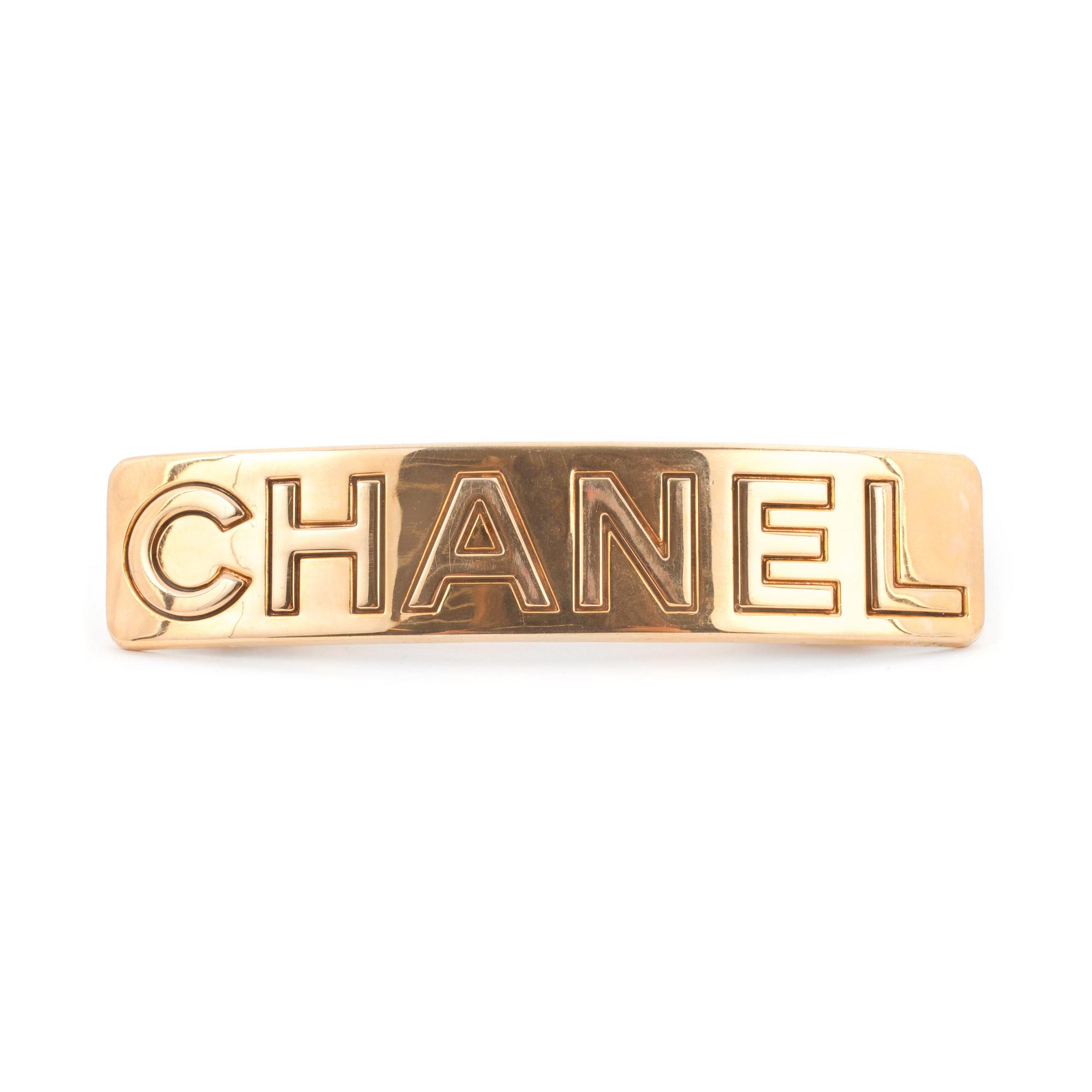 CHANEL, a gold colored metall hair clip.