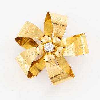 Brooch 18K gold with a white stone.