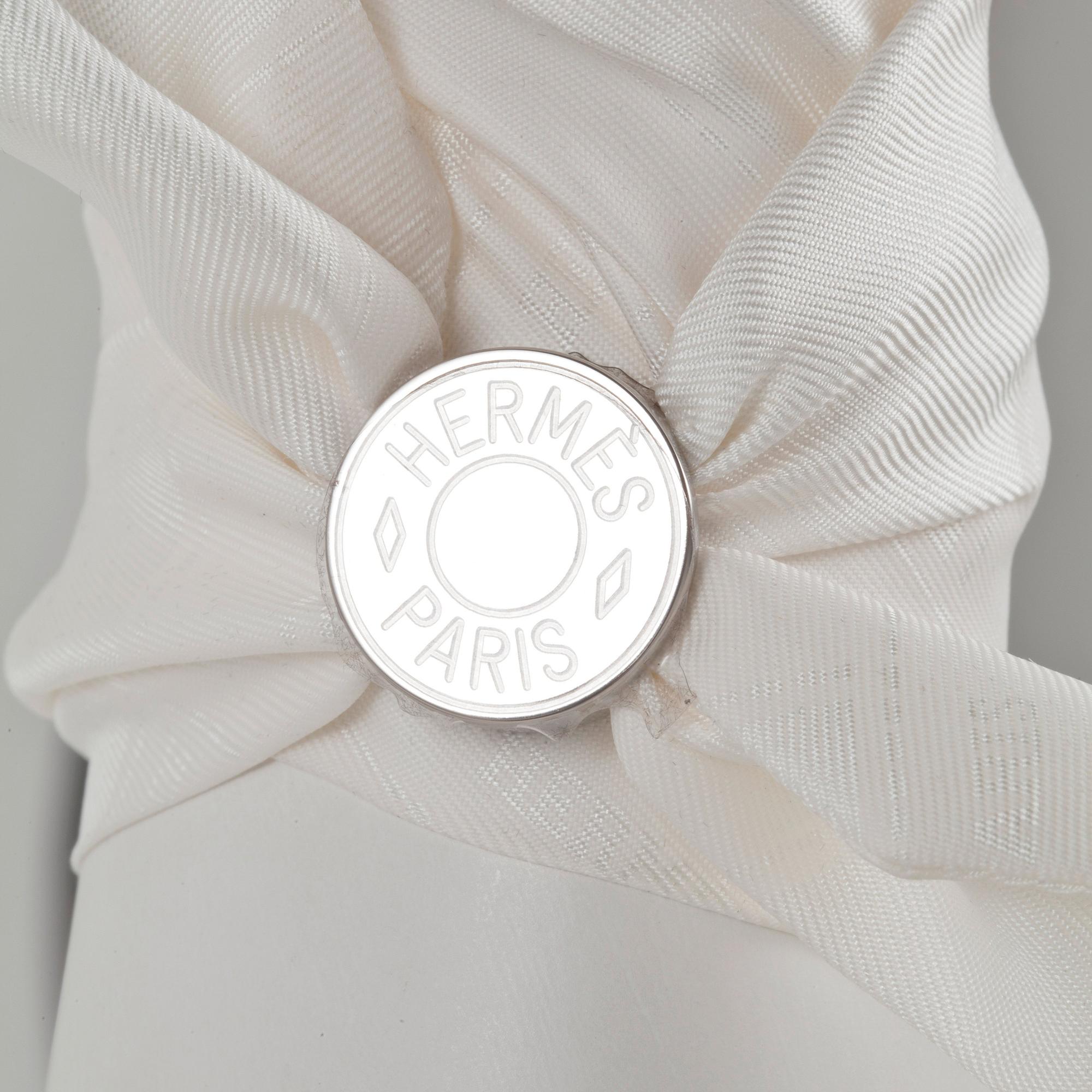 HERMÈS, three silk braclets with palladiumcovered locks.