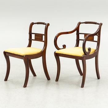 An Empire style dining table and ten chairs, second half of the 20th Century.