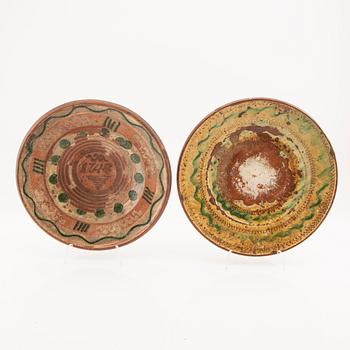 Two bowl plates ("Äggakagefat") 2 pieces from Skåne, one dated 1748 and 1891, engobed earthenware.