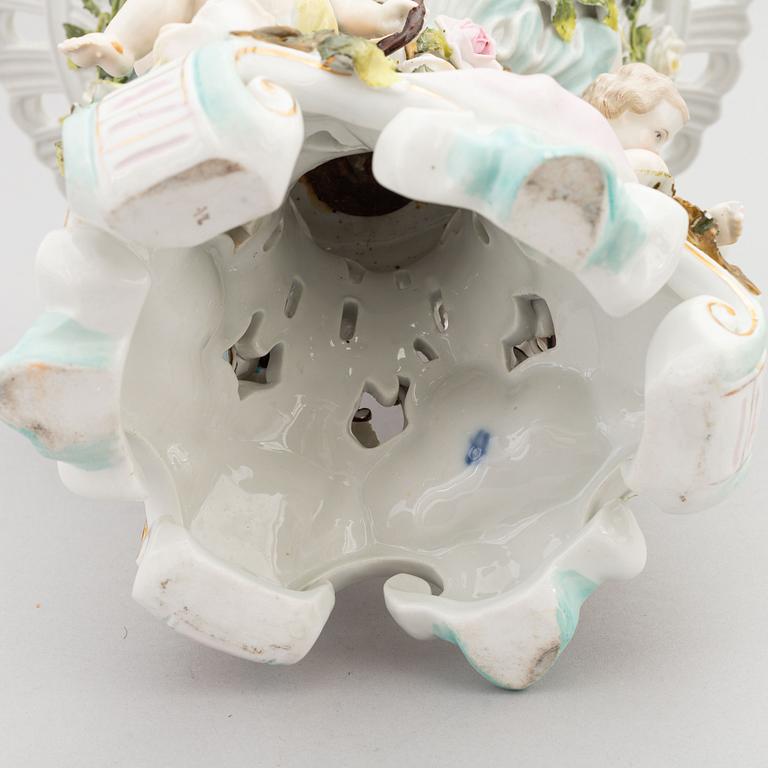 A pair of porcelain rococo style candelabra and a centerpiece bowl, Plaue, Germany, first half of the 20th century.