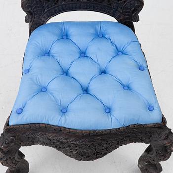 A carved 'blackwood' armchair.  bombay presidency circa 1880.
