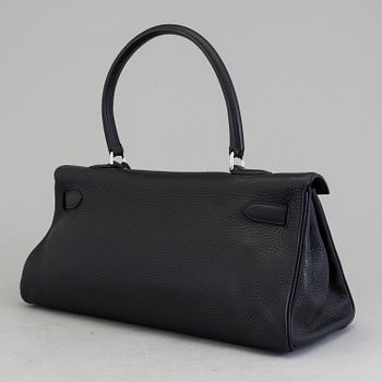 A black togo "JPG Shoulder Kelly 42" by Hermès 2009.