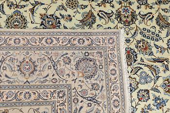A Keshan carpet, signed, approx. 398 x 301 cm.