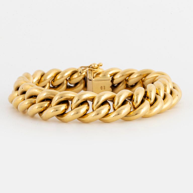 18K gold curb link bracelet.