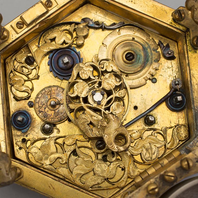 A gilded brass baroque travel clock from around 1700, with original case.