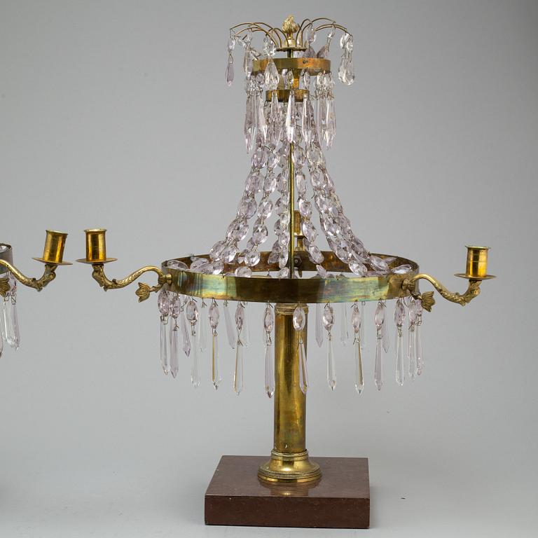 A pair of late Gustavian style three-light candelabra.