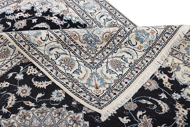 A Nain carpet, part silk, c. 286 x 206 cm.